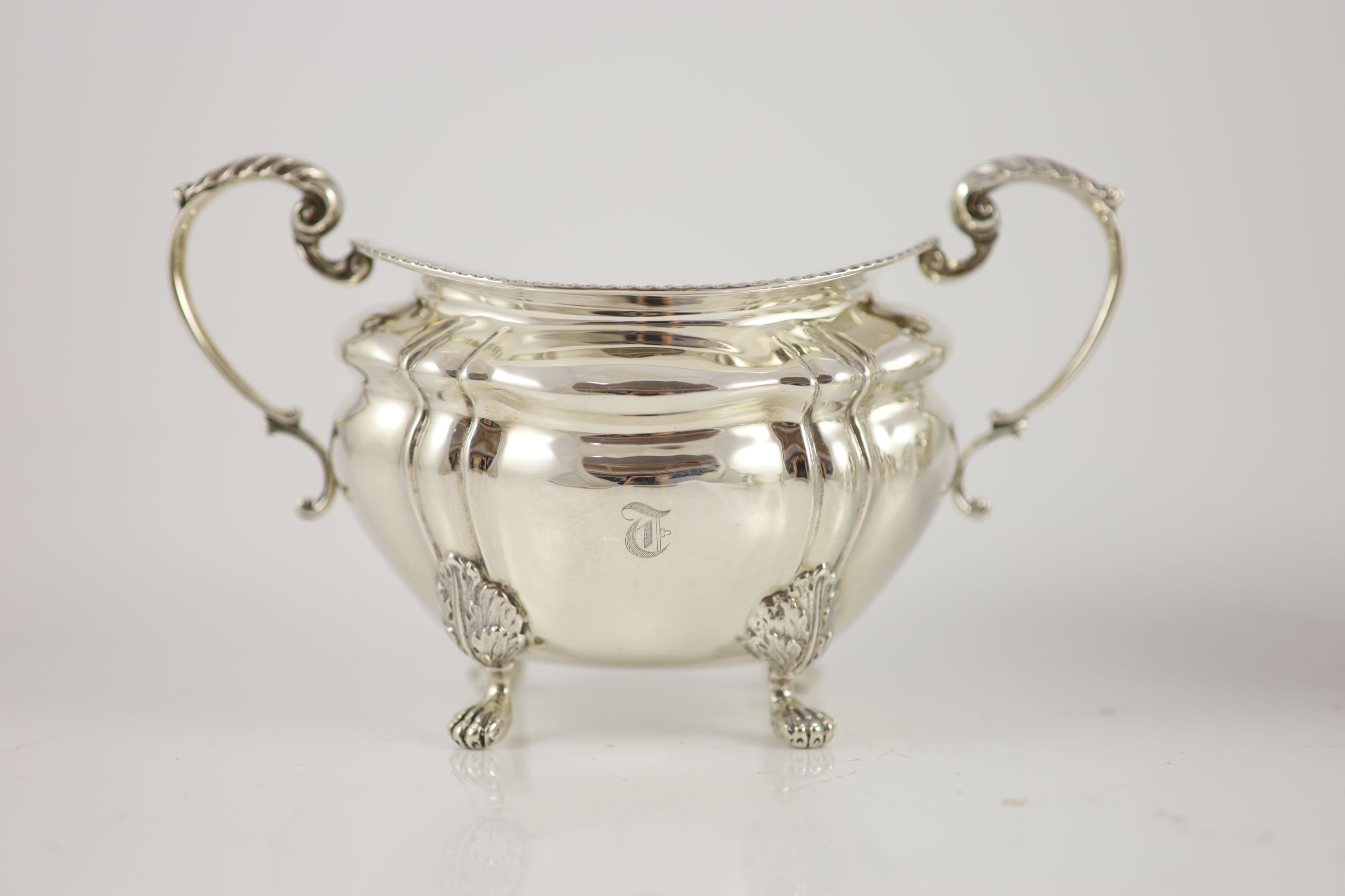 A late Victorian four-piece silver tea set comprising teapot, lidded bowl, twin handed sugar basin and jug with gilded bowls throughout, Josiah Williams & Co, London, 1900